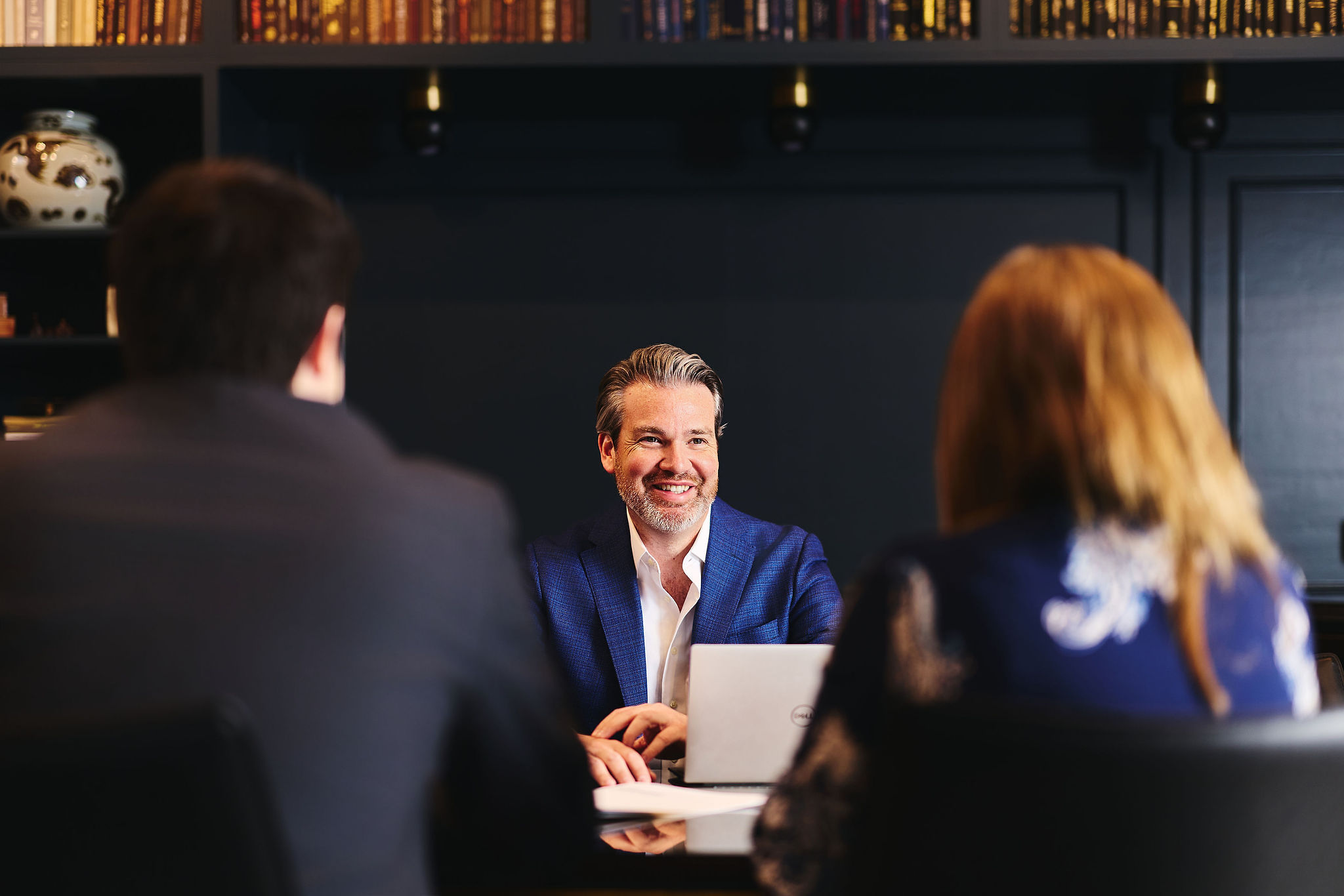 Experienced consultant presenting insights to clients in a professional meeting